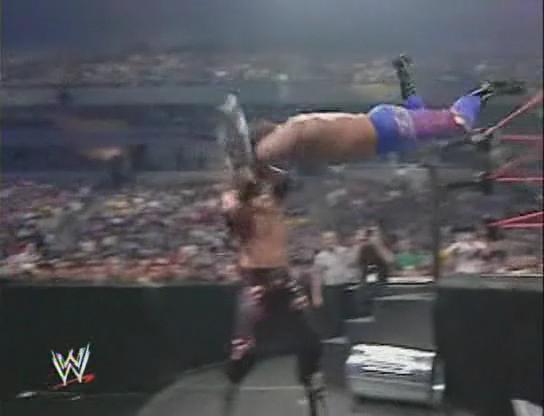 Chris Benoit taking a steel chair shot to the head during a missed Flying Headbutt.